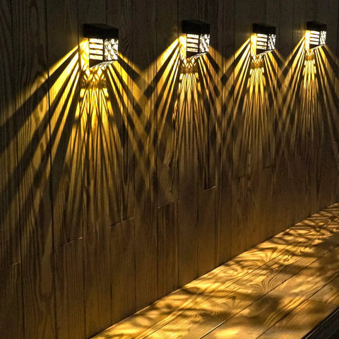 Halloween Solar Deck Lights Outdoor Waterproof LED Garden Decor 4 Pack illuminating wooden wall with warm glow
