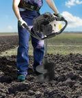 Man operating Beast 72cc Gas Powered Post Hole Digger with 4.1HP Heavy Duty Earth Auger in a field, earth auger visible.