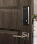 Smart Door Lock Deadbolt with Touchscreen Keypad, Pin Codes and Key Entry, installed on a wooden door in a kitchen.
