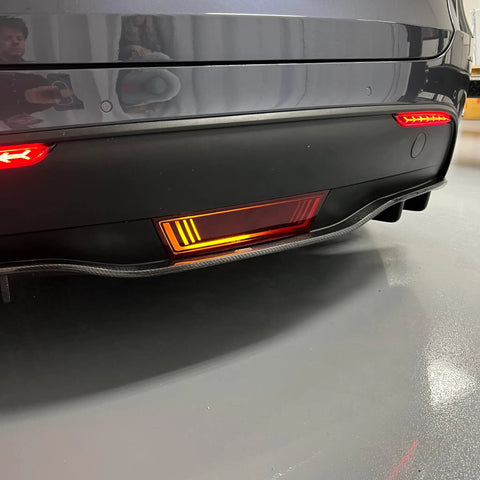 Dope Tesla Model Y Led Brake And Turn Signal Kit With Smoke Tint Lens Replaces Hitch Cover Straight Plug And Play Zero Hassle Swap, shown from below.