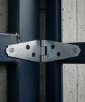 Heavy Duty 6 Pack T Hinges With Mounting Screws For Barn Doors And Gates on a blue metal gate, showcasing durable steel material.