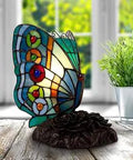Tiffany Style Butterfly Lamp With Stained Glass Art on wooden table, colorful handcrafted glass gives cozy glow, perfect for desk or bedside.