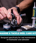 Person using Marine Reel Care Kit with oil and grease for freshwater and saltwater reels, including syringe, oiler, and swabs