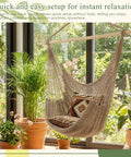 Two Piece Hanging Hammock Chair Set Boho Swing For Indoor Outdoor Chill Vibe Ultra Soft Cotton Rope Weaving Includes 40 Inch Detachable Metal Bars Solid 270lb Capacity Brown in a cozy indoor setting.