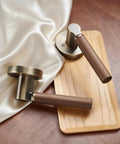 Walnut Wood Decorative Door Lever Two Pack With Antique Brass Finish Zinc Alloy Base Non Locking Dummy Handle For Interior Doors Warm Touch And Premium Cozy Vibe, two levers on display