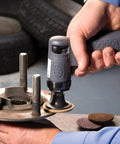 Person using Mini Surface Prep Sander Kit With 14-Piece 2-Inch And 3-Inch Sanding Discs on automotive part in garage.