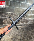 Polypropylene Bokken Training Sword Broadsword 43.5 Inch Blunt Practice Weapon held vertically against a brick wall