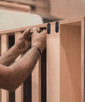 Person installing Stainless Steel Straight Bracket Set 24 Pcs For Furniture Repair And Wood Joining Black Flat Corner Braces