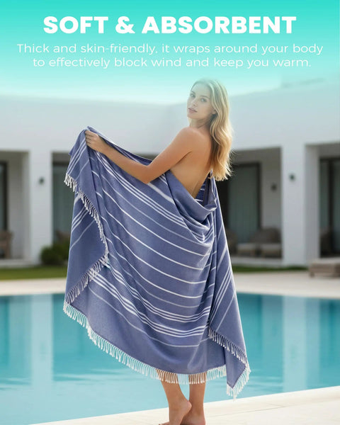 Woman wrapped in oversized boho Turkish beach towel blanket quick dry sand free jumbo outdoor picnic mat extra large XL navy.