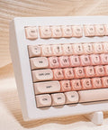 Close-up view of Clean 80 Percent Wireless Mechanical Keyboard In Soft Pink Creamy Build Featuring Jelly Moa Profile Transparent Keycaps.