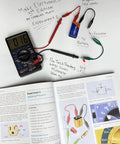 Hands-On Compact Electronics Kit Mini Pack for Charles Platt Third Edition Electronics Book Includes Resistors, Capacitors, LEDs, and Small Components to Complete Experiments 1 Through 5 ProTechTrader Quality with multimeter and circuit components on page.