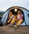 Couple camping with tent lantern using 40LB Magnetic Hooks With Carabiner 8-Pack Ultra Strong Camping Tent Hooks For Lanterns And Gear
