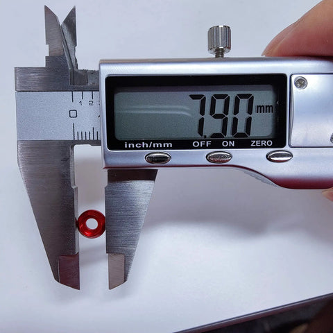 Measuring a red M3 counterbore washer with calipers at 7.90mm for Top Shelf 60 Pack M3 Counterbore Washers In Sweet Golden Anodized Aluminum Alloy Finish And Rock Solid Grip Perfect For Rc Drone Fpv Toys Mechanical Screw Sets No Sweat Assembly.