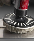 Hand using Roloc Bristle Disc Kit 982BS, 2 Inch Pack Of 5 for deburring metal surface with flexible bristles and abrasive grain.