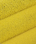 Close-up of yellow foam material used in 10 Pack 4 Inch Foam Paint Roller Kit With Heavy Duty Spring Handles For Smooth Rollouts And Clean Edge Trimming Ideal For Latex Or Oil Based Coatings On Interior Walls.