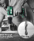 Man using green and black drill on wood surface