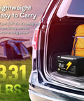 12V 12Ah LiFePO4 Battery with Built In BMS IP67 Waterproof displayed in an open car trunk next to camping gear