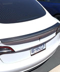 Real Molded Carbon Fiber Matte Dry Look Spoiler For Tesla Model 3 mounted on rear trunk, showcasing lightweight and aerodynamic design.