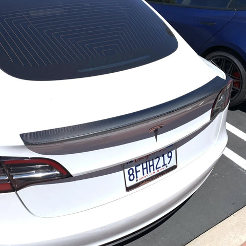 Real Molded Carbon Fiber Matte Dry Look Spoiler For Tesla Model 3 mounted on rear trunk, showcasing lightweight and aerodynamic design.