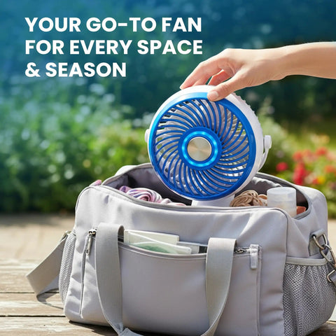 Blue Steel Portable Desk Fan With 360 Degree Oscillation placed in a bag outdoors, ideal for home office travel and outdoor camping.