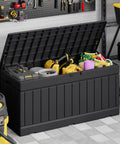 78 Gallon Waterproof Resin Deck Box With Lockable Bench open in garage with tools and cleaning supplies inside, black resin with rattan pattern