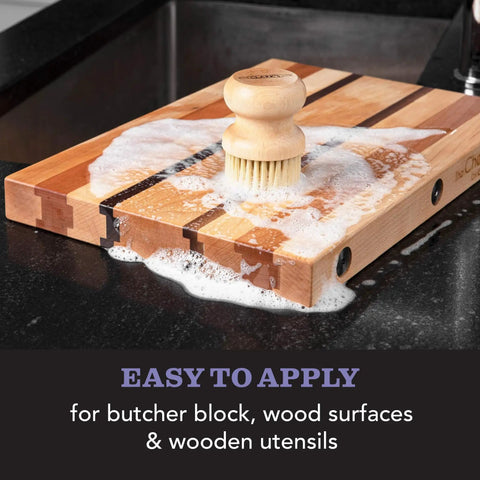 All-In-One Cutting Board Care Kit With Mineral Oil And Finishing Wax Includes Applicator Scrub Brush Buffing Pad And Lavender Rosemary Infused Wood Wax For Long Lasting Board Protection And Conditioning applied on wooden board