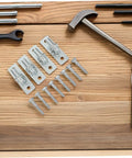 4 Pack Wall Mount Gate Hinges For Barn And Metal Doors Hella Heavy Duty Farm Gate Hardware with screws on wooden surface.