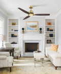56" Soft Brass Chandelier Ceiling Fan,2 Downrods Fandelier with Remote in a modern living room setting with wood blades.