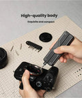 Person using the 13-in-1 Full-Size Multitool With Ratcheting Screwdriver And Pliers Functions on a camera lens.