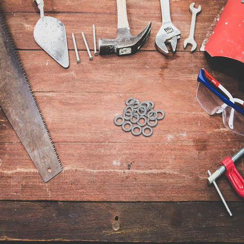 Set Of Twenty M10 Wedge Locking Washers Built Tough With Premium Manganese Steel on a workbench among tools