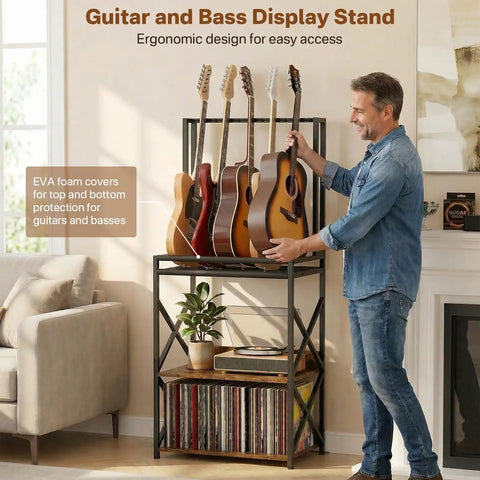 Show Off Your Sweet Guitar Collection With This Super Cool 3 Tier Music Stand. Holds Five Strummers Safe And Sound. Built-In Vinyl Record Spinning Rack For That Retro Vibe. Sturdy, Stylish, And Ready To Rock Your Home Or Studio Space Today. - Man adjusting guitars on ergonomic bass display stand with vinyl records below.