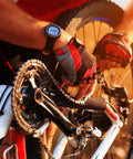 Cyclist installing 8 Pack Bicycle Missing Link Master Links For 6 To 10 Speed Chains on a road bike, wearing red gloves.