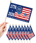 Hand holding 12 Pack 250th Anniversary Flags 5x8 Inches Handheld Polyester Double Sided With Wooden Poles for celebration