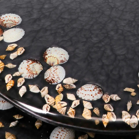 Close-up of Deluxe Resin Maui Decorative Elongated Toilet Seat With Slow Close And No Slam Chrome Hinges For Coastal Beach House Decor Shells Theme Durable Reinforced Resin Construction showing shell details.