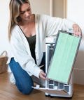 Woman installing MA-40 Replacement Filter for Allergens Smoke Dust Odors Pollen and Pet Dander 3 in 1 with Pre Filter True HEPA H14 Activated Carbon