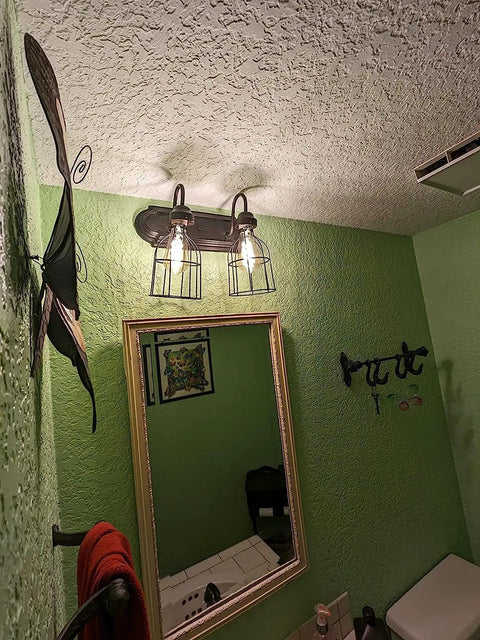 Premium Black Metal Wire Cage Lamp Guard For Ceiling Fans And Pendant Lights Killer Diamond Shape Light Cover with two bulbs showcased above a mirror