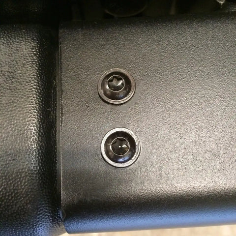 Close-up of heavy duty hardened torx screws for Jeep Wrangler TJ bumper end caps, showing durable black finish.