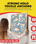 Heavy Duty Drywall Anchors And Screws Kit With Toggle Anchors Self Drilling Zinc Plastic For Secure Hanging Of Pictures And Shelves Includes 25 Pack Durable Corrosion Resistant Fasteners For Quick Install being used to hang artwork