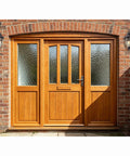 Big Ol 23 Inch Outdoor Porch Light With Antique Bronze Finish on brick wall beside wooden door with clear seeded glass