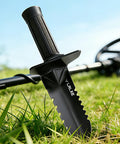 Heavy Duty Serrated Edge Metal Detecting Shovel With Belt Loop Sheath standing upright in grass