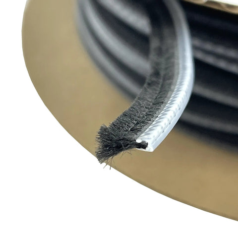 Close-up of 0.312 Inch Adjustable Astragal Replacement Pile Weatherstrip, 100 Foot Roll showing black fiber pile and clear backing
