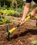 Person using Heavy Duty 24 Inch Pick Mattock Hoe with Forged Steel Head and Fiberglass Handle for Loosening Soil in Garden