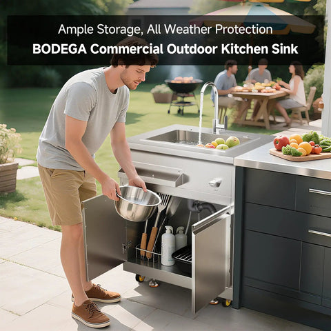 Stainless Steel Outdoor Kitchen Sink With Faucet Kit Hose Hookups Single Bowl Storage Brakes On Wheels Spice Rack All Weather Use Built To Last For RV Yard Garage Restaurants in use on a patio with open cabinet showcasing storage.