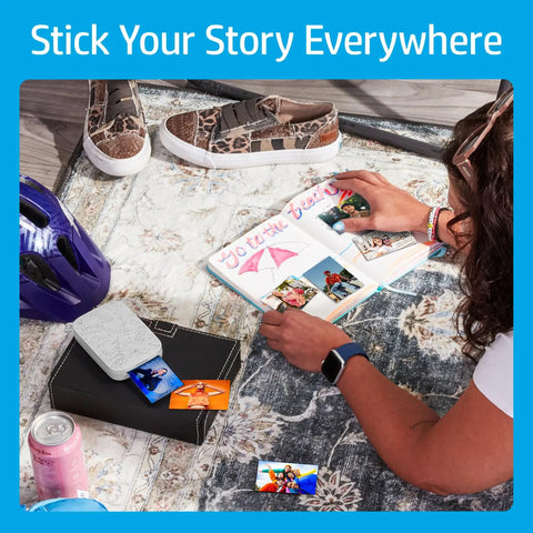 Person using Pocket Sized Photo Printer For Instant Two By Three Inch Sticky Back Photos From Your Phone On The Go Luna Pearl Edition.