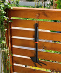 Dual Head Hand Hoe Garden Tool Set For Weeding And Cultivating In The Yard And Garden hanging on wooden fence