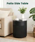 Black round table beside beige sofa with houseplant, labeled 'Patio Side Table', showing indoor use for Tough As Nails 90lb Water Filled Patio Umbrella Base With Built In Ice Cooler 3 In 1 Outdoor Table With Umbrella Hole Fits 1.5 To 1.9 Inch Poles For Poolside Deck And Garden Black.