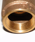 Brass 1-inch female-threaded check valve end, close-up view, with visible internal bore.