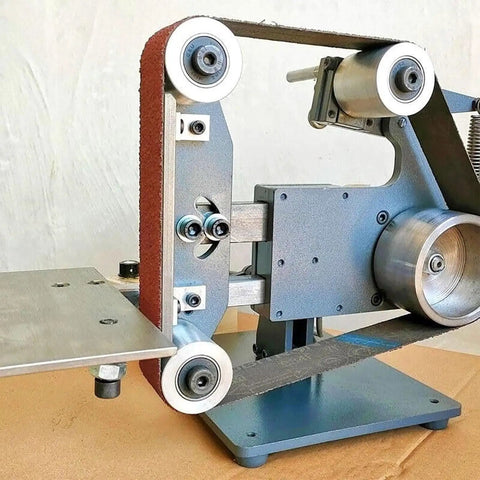 Close-up of Heavy Duty 750W Belt Sander With Brushless Motor And Variable Speed, showing sanding belt and steel base.