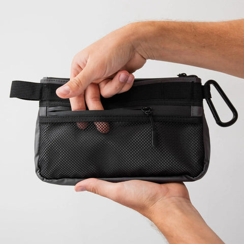 Person holding Small Black Electronics And Camera Accessories Bag With TPU Water Resistant Layer, featuring mesh outer pocket