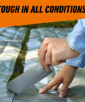 Person applying Tough As Nails Heavy Duty Duct Tape With Triple Layer Strength for Indoor and Outdoor Repairs on tarp outdoors.